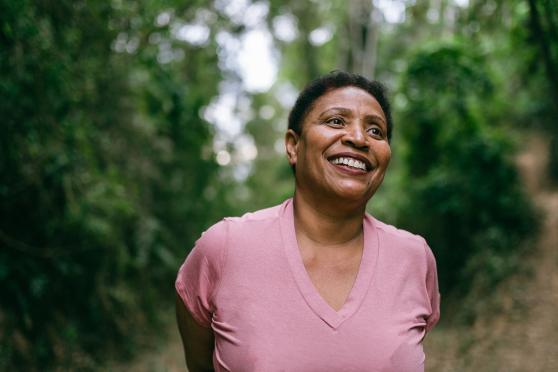 Woman walking outdoors and smiling